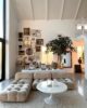 Living room with a cloud couch, floor-to-ceiling window and an array of photos on the wall