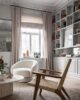 Living room with rattan rug and chair, marble coffee table and a cozy lounge chair