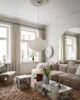 Living room with a rose pink rug, marble coffee table and cloud couches